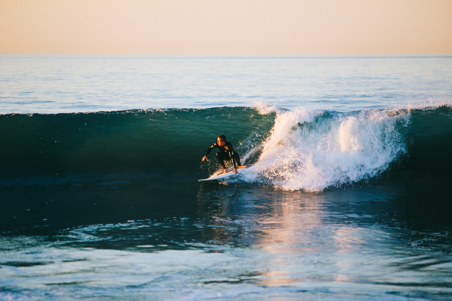 Photo by Austin Neill on Unsplash : Surfer surfing the wave at Newport Beach